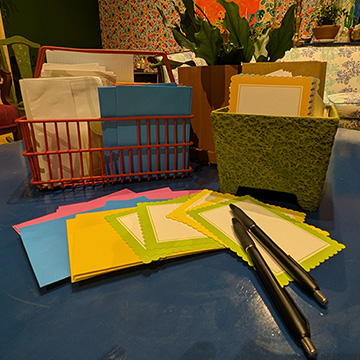 pens and blank letters laid out on a coffee table