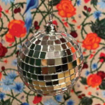 a disco ball and floral wallpaper