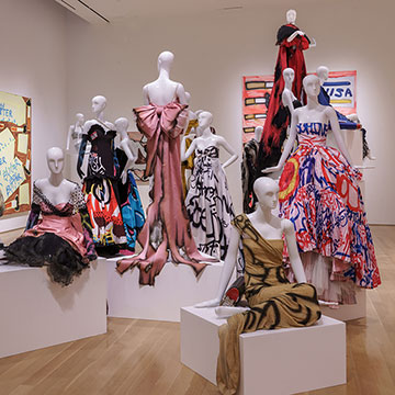 paintings and clothing designs on display at the Match Made in Heaven exhibition at the Nerman Museum of Contemporary Art in Overland Park Kansas