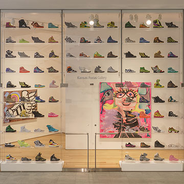 a large wall of shoes designed by Jeremy Scott
