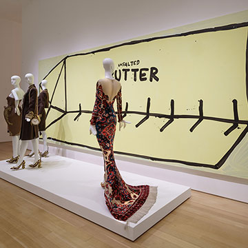 a large painting of butter and dresses designed by Jeremy Scott