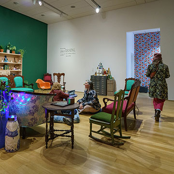 a view of the salon installation with patrons at the Nerman Museum